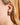 Ethical brass stud earrings by AARVEN featuring minimalist shape and hammered finish.